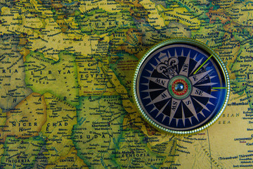 Compass on old map of the world. Journey and discovery concept