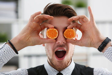 Male hands hold a cut fruit at eye level