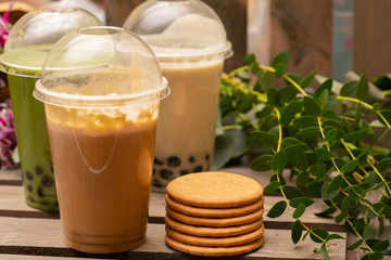  Fresh latte with cookies on wooden board