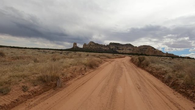 Desert landscape dirt road. San Rafael Swell geologic landscape south Utah. Sandstone limestone sedimentary valleys, canyons, gorges. Hikers,  off road all terrain vehicle (ATV) recreation.
