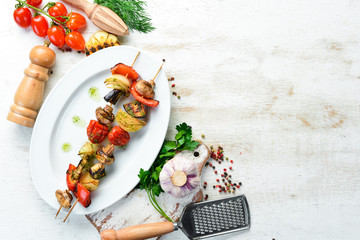 Vegetable skewers. Grilled vegetables: mushrooms, bell peppers, tomatoes and onions.