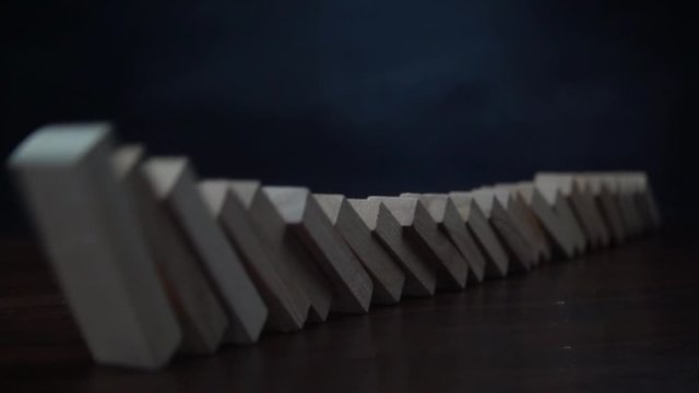 domino effect and overturning wooden blocks. slow motion.