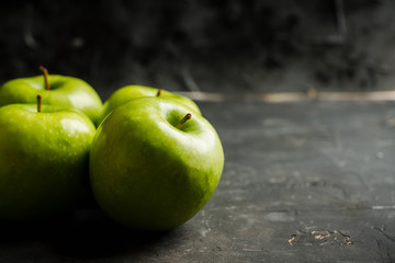 Close-up green apples on the rustic wooden background. Selective focus. Shallow depth of field.