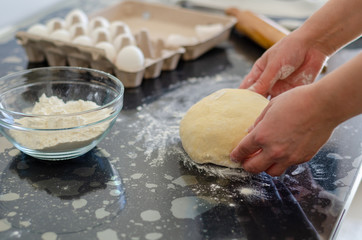 Woman hands preparing dough