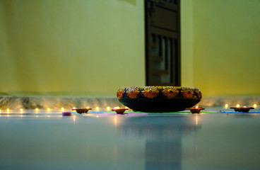 Happy Diwali - rangoli painting on floor for diwali with floating candles
