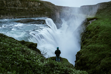 Man standing at Gullfoss waterfall