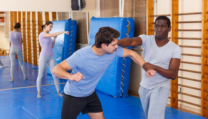 Two men practicing self defense techniques