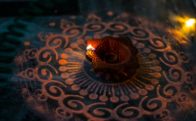 Happy Diwali - Colorful clay diya lamps lit during diwali celebration
