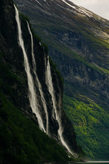 View towards Seven sisters waterfall and the rocky wall of Geirangerfjord in Norway 