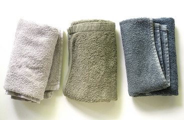 Three multicolored terry towels on a white background