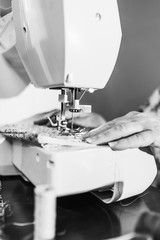 Women's hands behind her sewing