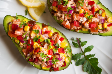 Avocado halves stuffed with tuna fish and vegetables