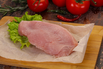Raw Turkey steak served rosemary