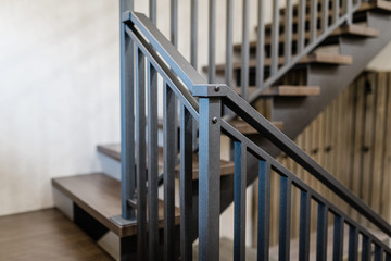 Wooden dark oak stairs with matte metal railings. Handmade stairs and railings. Modern style and design. Expensive and valuable materials.
