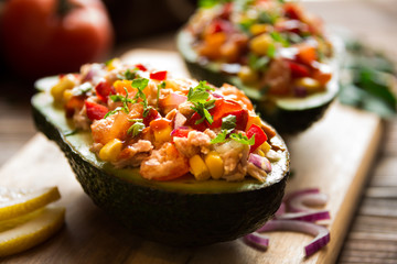 Avocado halves stuffed with tuna fish and vegetables