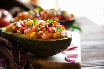 Avocado halves stuffed with tuna fish and vegetables