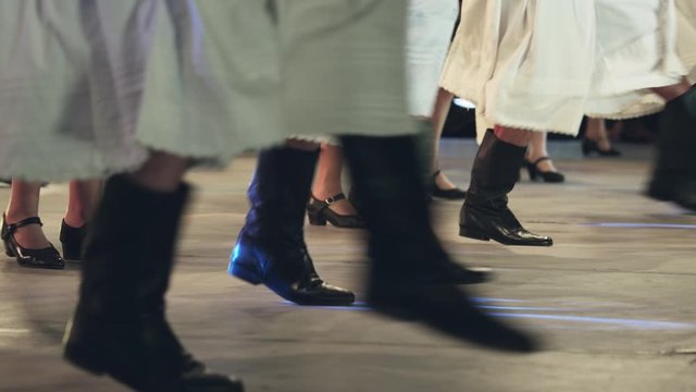 Traditional romanian folklore dancers in traditional costumes dancing on stage
