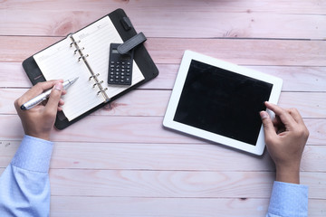 person hand analyzing financial data on digital tablet 