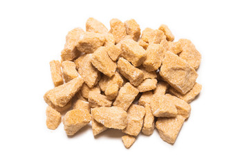 Brown sugar pieces isolated on white