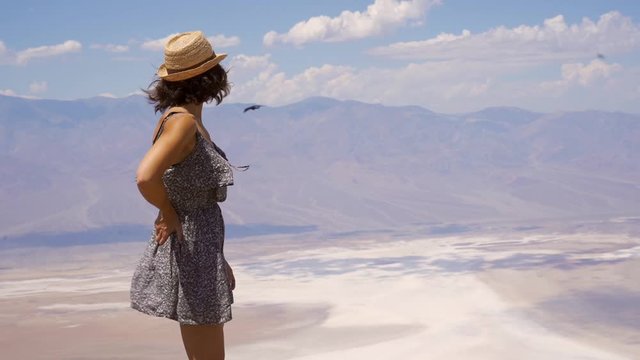 A young woman in dress on the beautiful viewpoint of Dante's view in Death Valley, California. United States