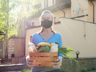 Volunteer work during the coronavirus pandemic. Portrait of a woman with a food set for the poor.