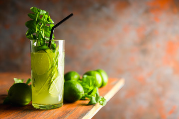 Mojito cocktail with lime and mint on the rustic background. Selective focus. Shallow depth of field.