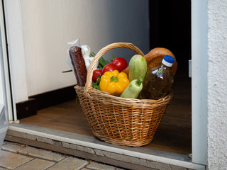 A basket of food on the doorstep during the period of quarantine. Social distancing.