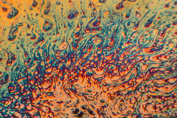 Soap bubbles taken in a black coffee mug. The microscopic look of the bubbles is achieved by using a lens from a rear projection TV as a macro filter lens. Noise and some grains added digitally