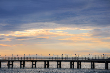Fototapeta na wymiar Empty sea pier without people at sunset.