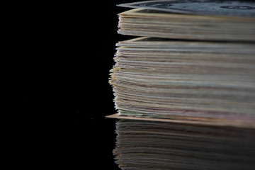 A stack of paper American dollars, photographed in close-up.