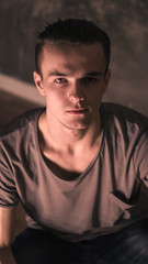 Fototapeta premium young guy sitting on the floor at home a warm beam will fall on his face