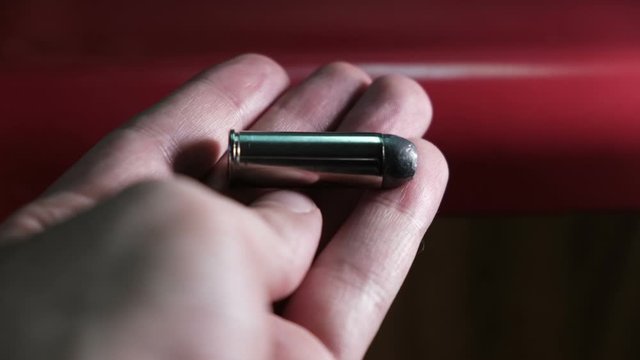 colt 45 bullet in hand