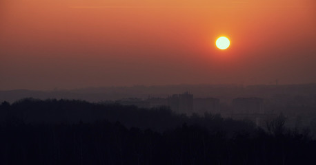 Orange sunset seen from the Krak's Mound in the background smog over the city - obrazy, fototapety, plakaty