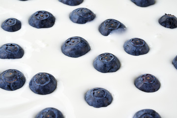 Blueberries pattern dropped in yoghurt
