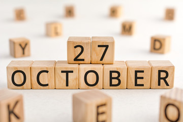 October 27 - from wooden blocks with letters, important date concept, white background random letters around