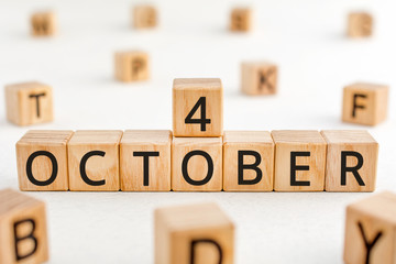 October 4 - from wooden blocks with letters, important date concept, white background random letters around