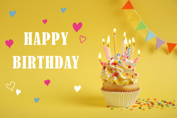 Text Happy Birthday and delicious cupcake with burning candles on yellow background