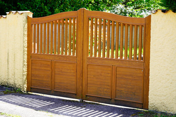 Brown wooden gates of private house suburb wood portal door