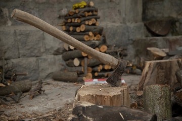 an ax on a wooden trunk