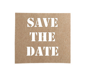 Piece of notebook paper with phrase SAVE THE DATE on white background, top view