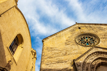 Exterior high section low-angle partial view of Church of San Biagio to the left and Church of San Nicola dei Greci to the right in the old town of Altamura, Apulia, Italy