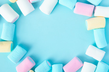 bright multi-colored marshmallows on a blue background