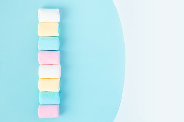 bright multi-colored marshmallows on a blue background