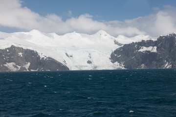Antarctica landscape with ocean and mountains on a clear winter day