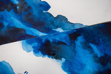 High angle view of paper with japanese painting with bright blue watercolor