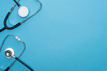 top view of stethoscopes on blue background