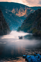 Canyon Matka near Skopje with people kayaking and amazing foggy scenery - obrazy, fototapety, plakaty