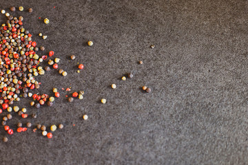 Red, green and black pepper on the black background. Peppercorn 