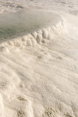 Blue steamy water of the spring in limestone pools in Pamukkale, Turkey