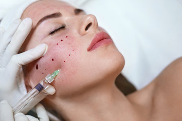 Face Treatment. Hyaluronic Acid Skincare Injection In Cosmetic Clinic. Beautician Does Anti Aging Beauty Procedure.